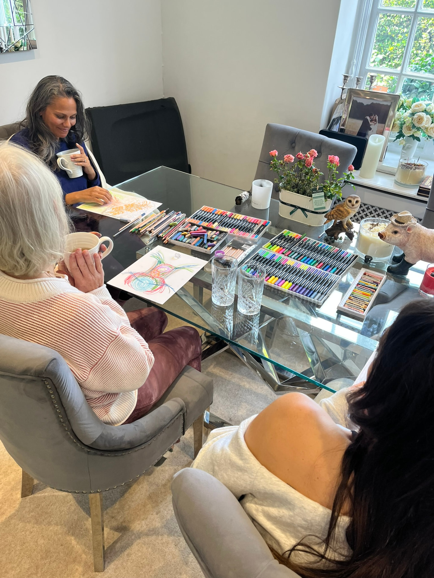 Guests creating intuitive art together around a table